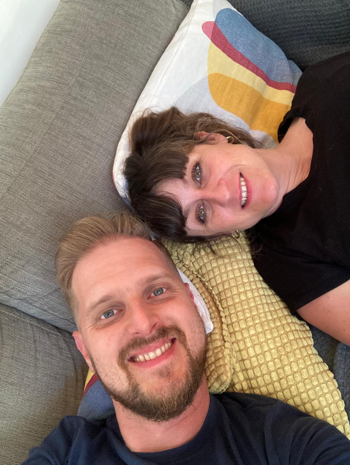Stef and Laz relaxing together on a couch